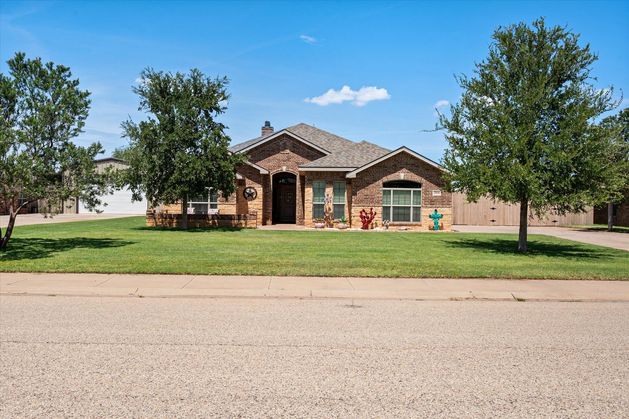 3106 128th Street Lubbock, TX 79423 - Photo 2 of 44 a front view of a house with a yard