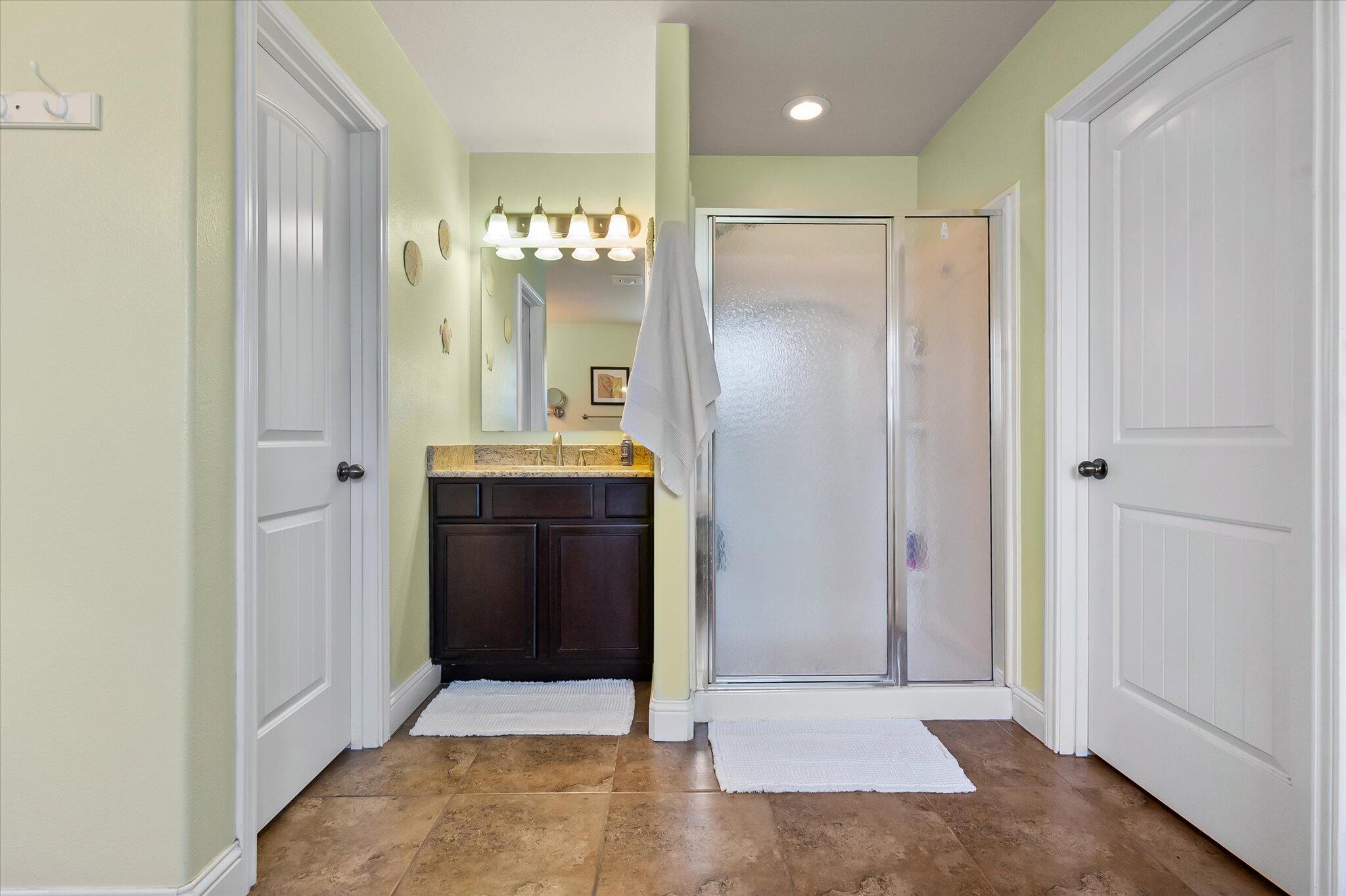 3106 128th Street Lubbock, TX 79423 - Photo 25 of 44 a bathroom with a mirror and a shower