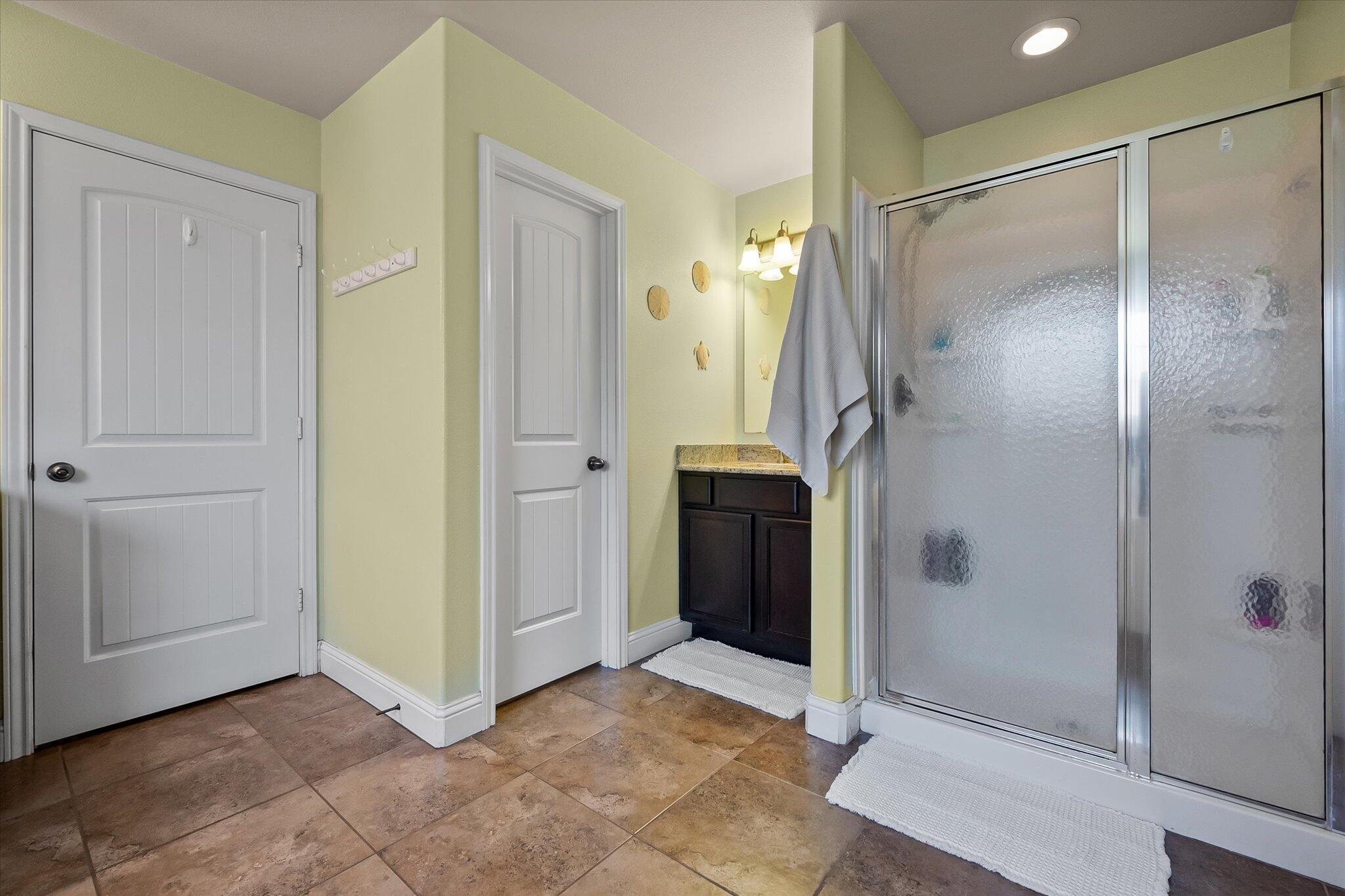 3106 128th Street Lubbock, TX 79423 - Photo 26 of 44 a bathroom with a glass shower door and a glass door