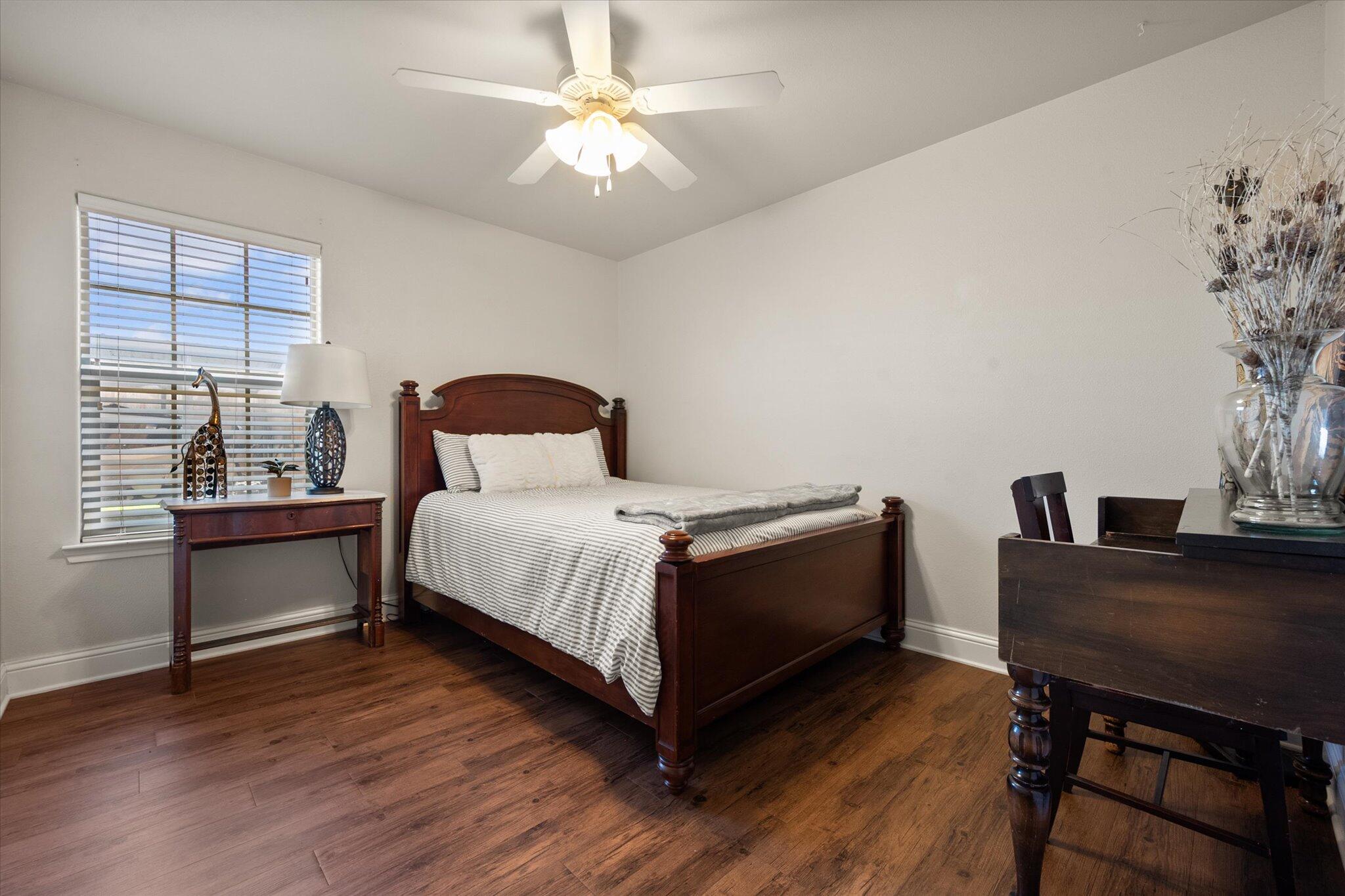 3106 128th Street Lubbock, TX 79423 - Photo 29 of 44 a bedroom with a bed and a table in it