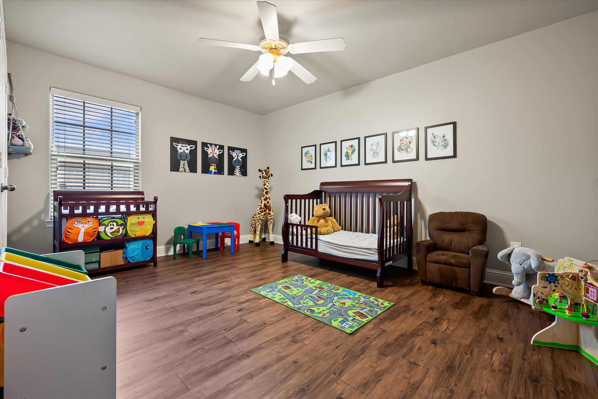 3106 128th Street Lubbock, TX 79423 - Photo 33 of 44 a bedroom with furniture and a wooden floor