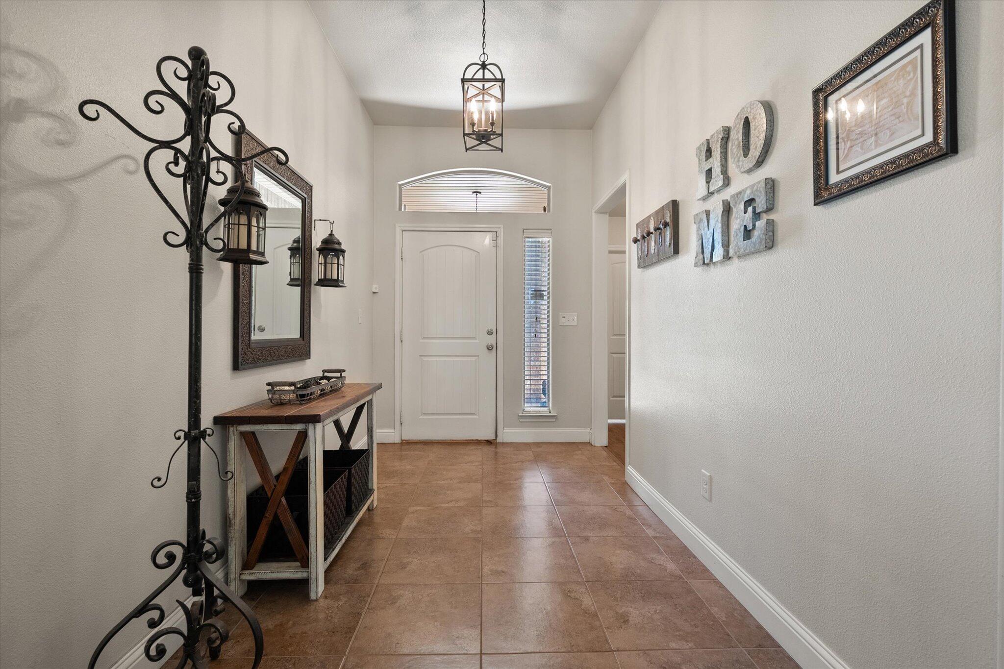 3106 128th Street Lubbock, TX 79423 - Photo 7 of 44 a view of a hallway with wooden floor and entryway