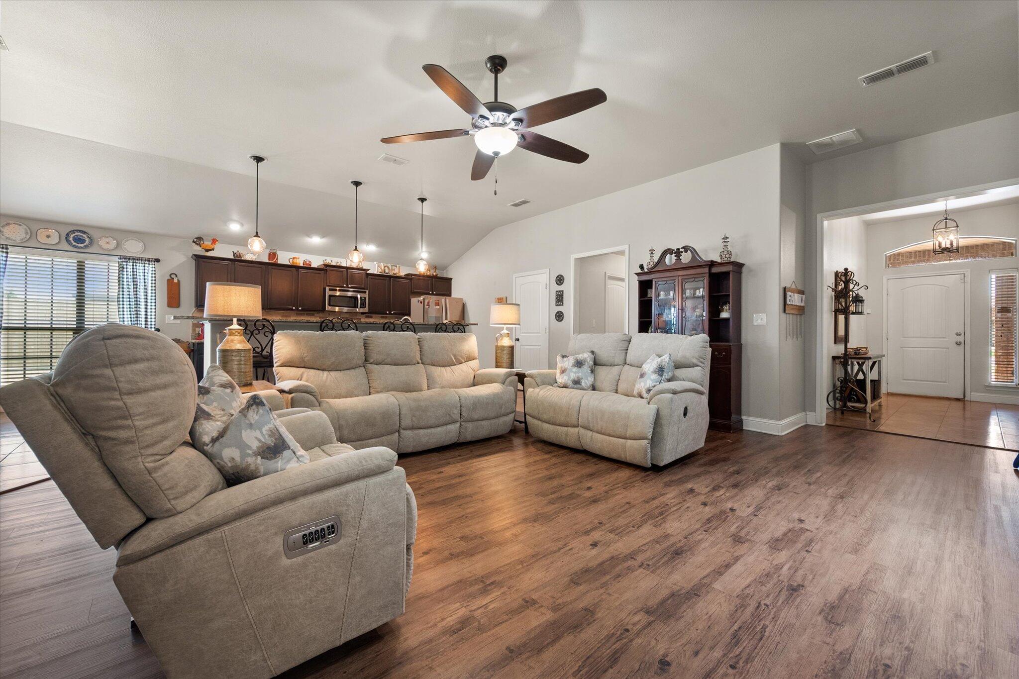 3106 128th Street Lubbock, TX 79423 - Photo 8 of 44 a living room with furniture kitchen view and a chandelier
