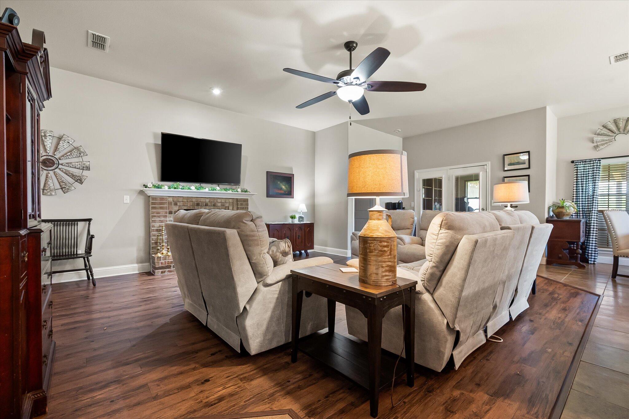 3106 128th Street Lubbock, TX 79423 - Photo 10 of 44 a living room with furniture a flat screen tv and kitchen view