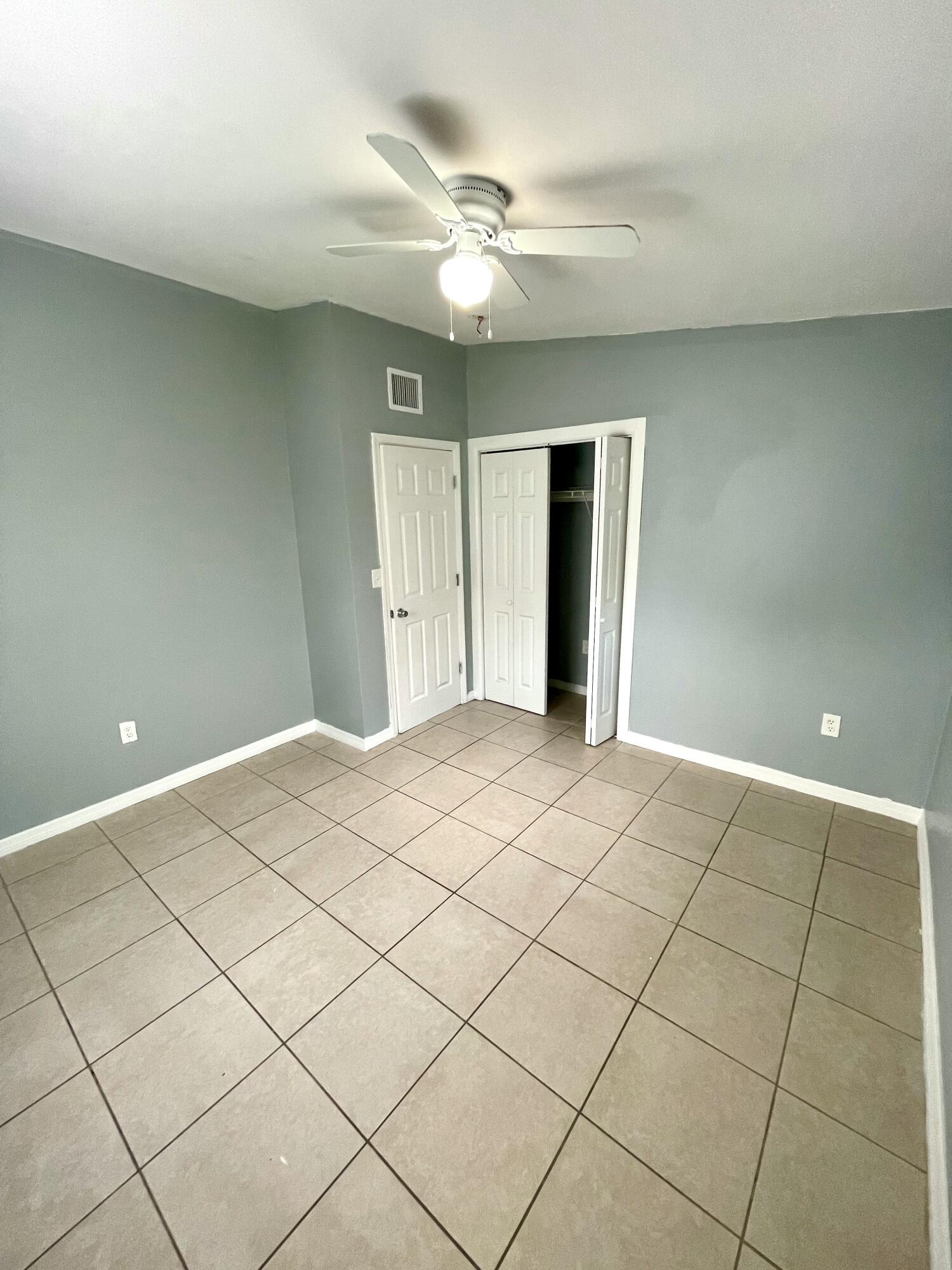 640 54th Street, Unit A West Palm Beach, FL 33407 - Photo 11 of 13 a view of a livingroom with a ceiling fan and window