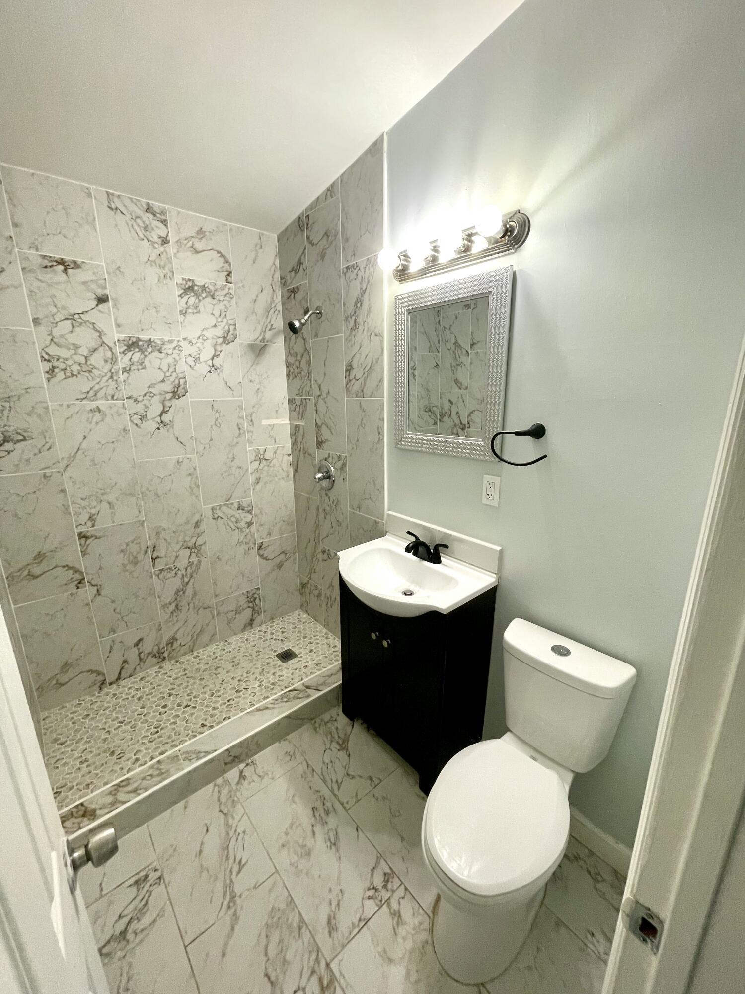 640 54th Street, Unit A West Palm Beach, FL 33407 - Photo 10 of 13 a bathroom with a sink toilet and shower