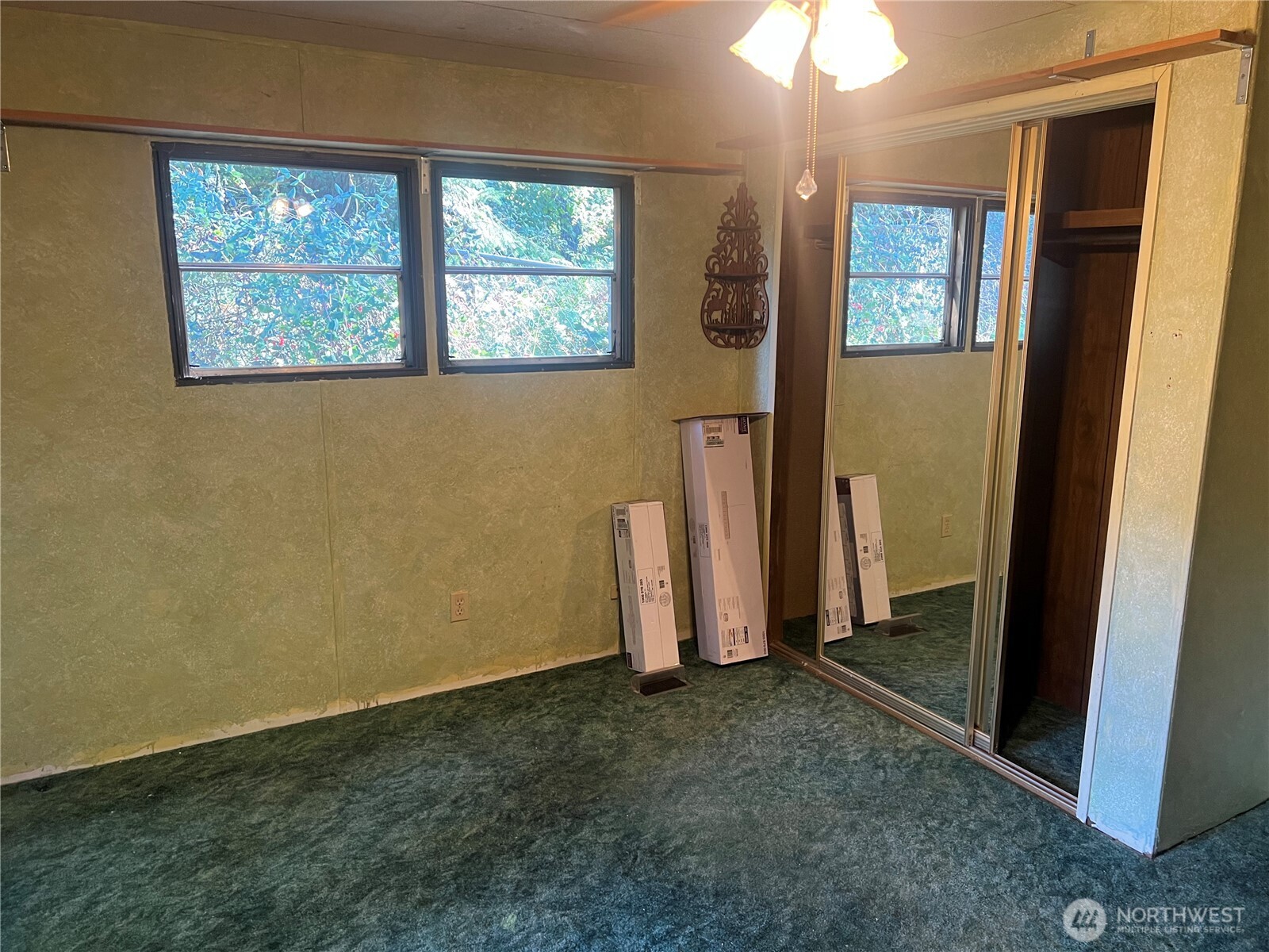 6402 154th Street Northwest, Unit 40 Gig Harbor, WA 98332 - Photo 18 of 23 an empty room with a window and chandelier fan