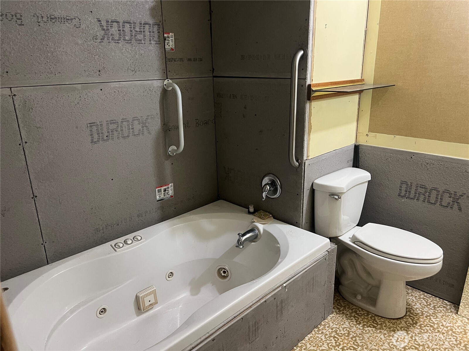 6402 154th Street Northwest, Unit 40 Gig Harbor, WA 98332 - Photo 21 of 23 a white bath tub sitting next to a white toilet