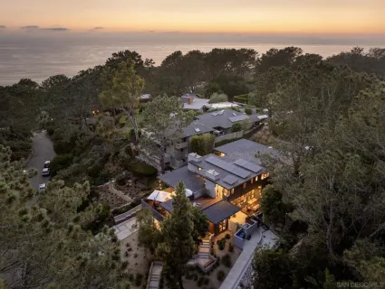a living room with furniture a flat screen tv and a floor to ceiling window