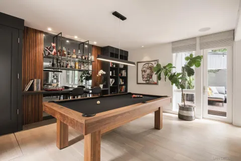 a kitchen with stainless steel appliances kitchen island granite countertop a table chairs and a refrigerator