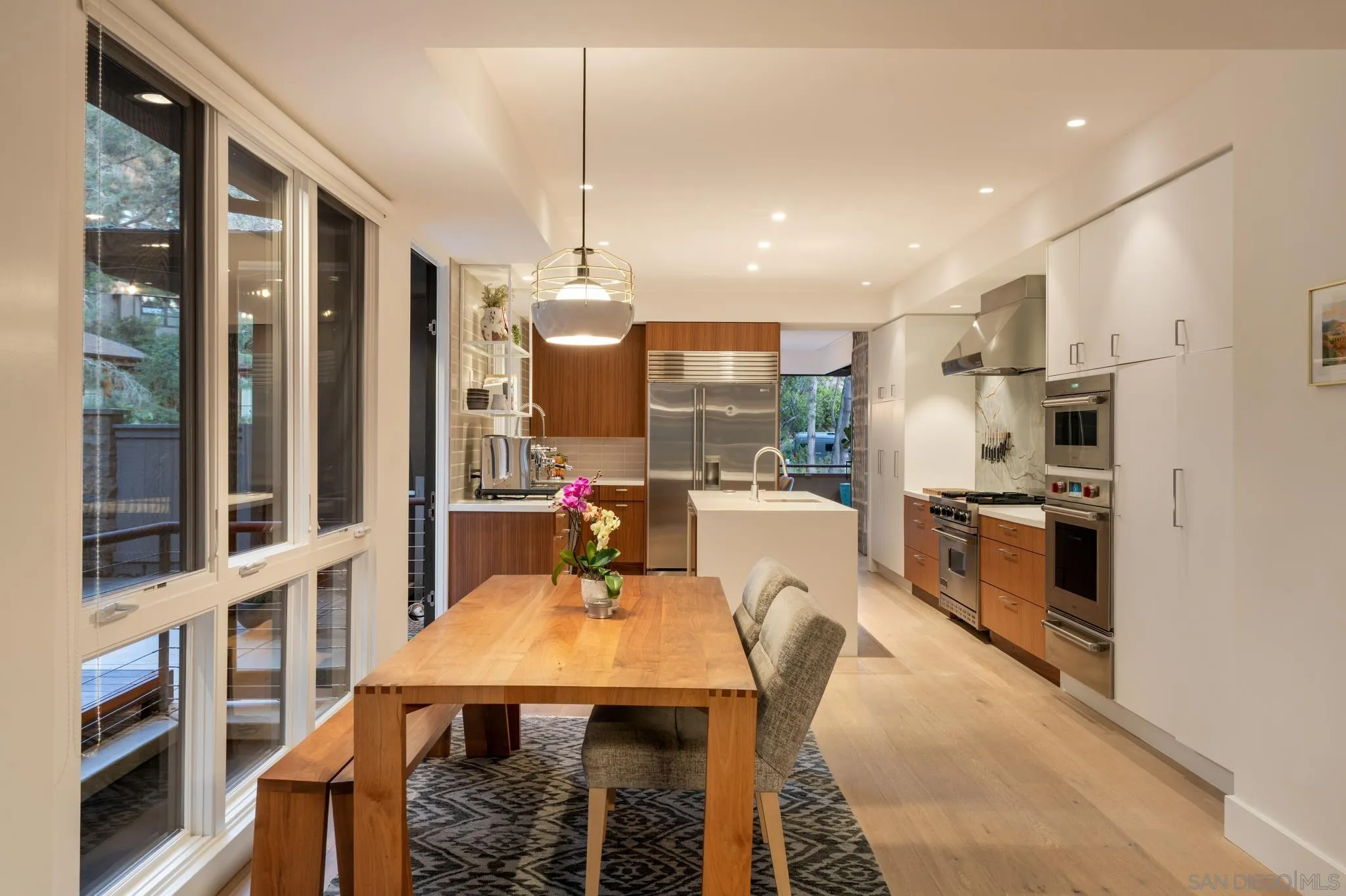 404 Pine Needles Drive Del Mar, CA 92014 - Photo 15 of 71 a kitchen with stainless steel appliances kitchen island granite countertop a table chairs and a refrigerator