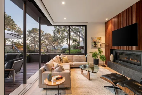a living room with furniture a flat screen tv and a fireplace