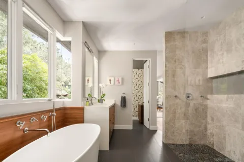 a bathroom with double vanity and a mirror