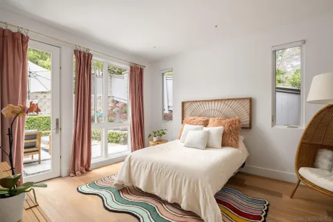 a bedroom with a bed and a painting on the wall