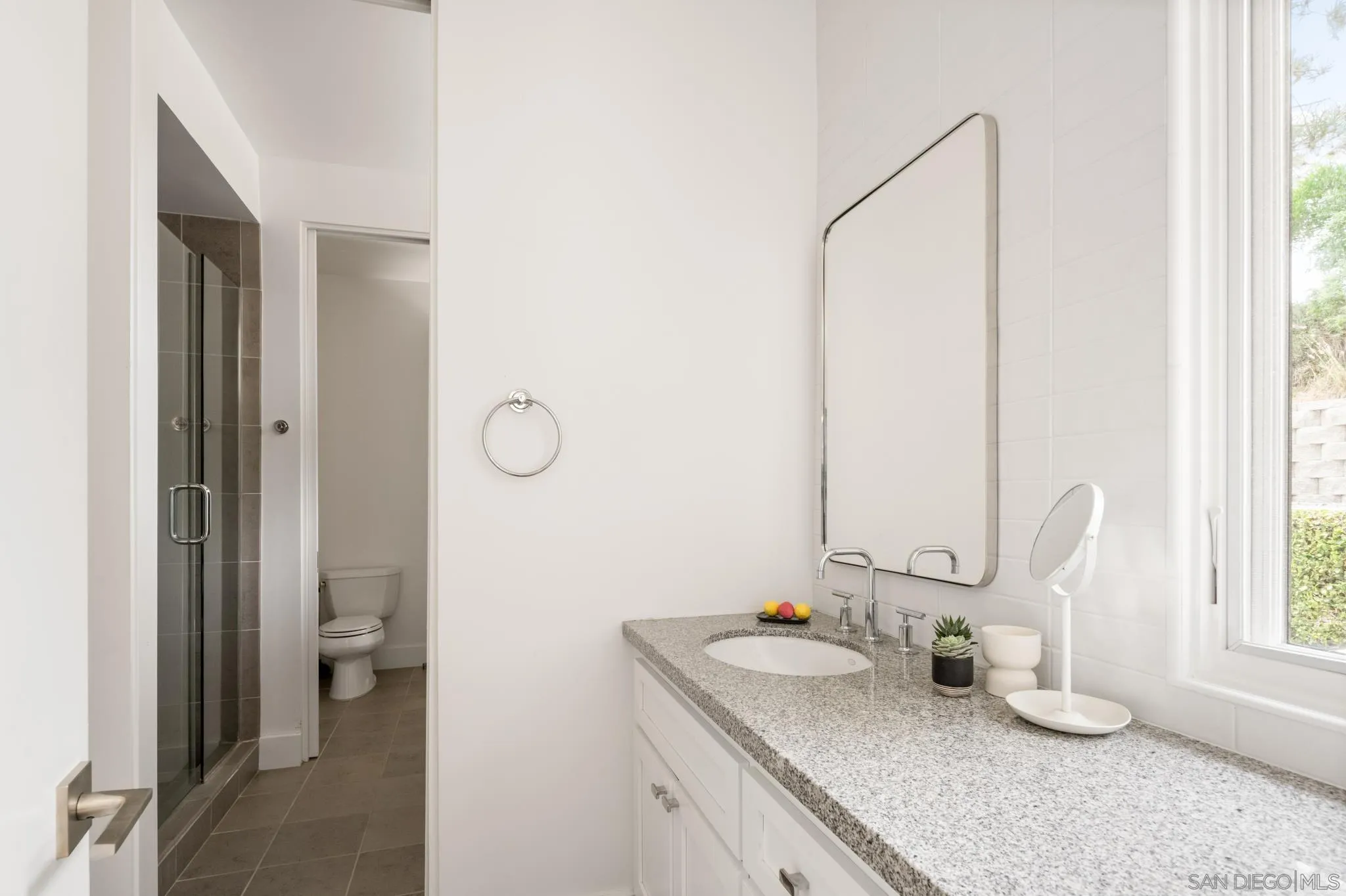404 Pine Needles Drive Del Mar, CA 92014 - Photo 35 of 71 a bathroom with a granite countertop sink and a mirror