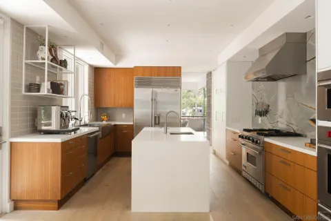 a kitchen with a sink and a stove top oven
