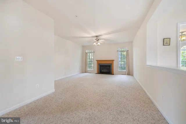 a view of a livingroom with a ceiling fan and window