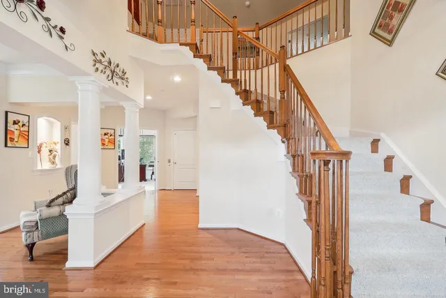 a view of a livingroom with wooden floor and stairs