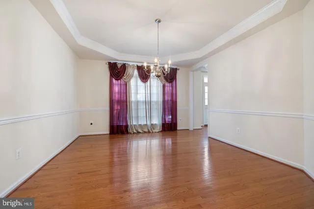 a view of an empty room with a fireplace and a window