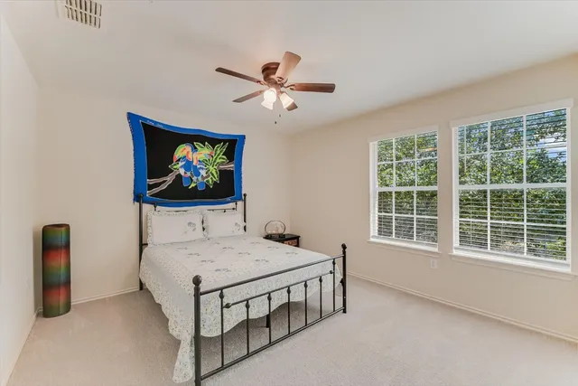 a bedroom with furniture and a flat screen tv