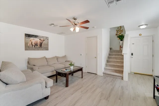 a living room with furniture and wooden floor