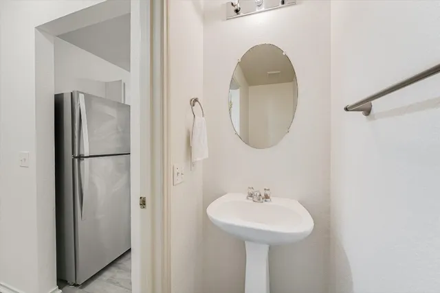 a bathroom with a sink a mirror and a shower