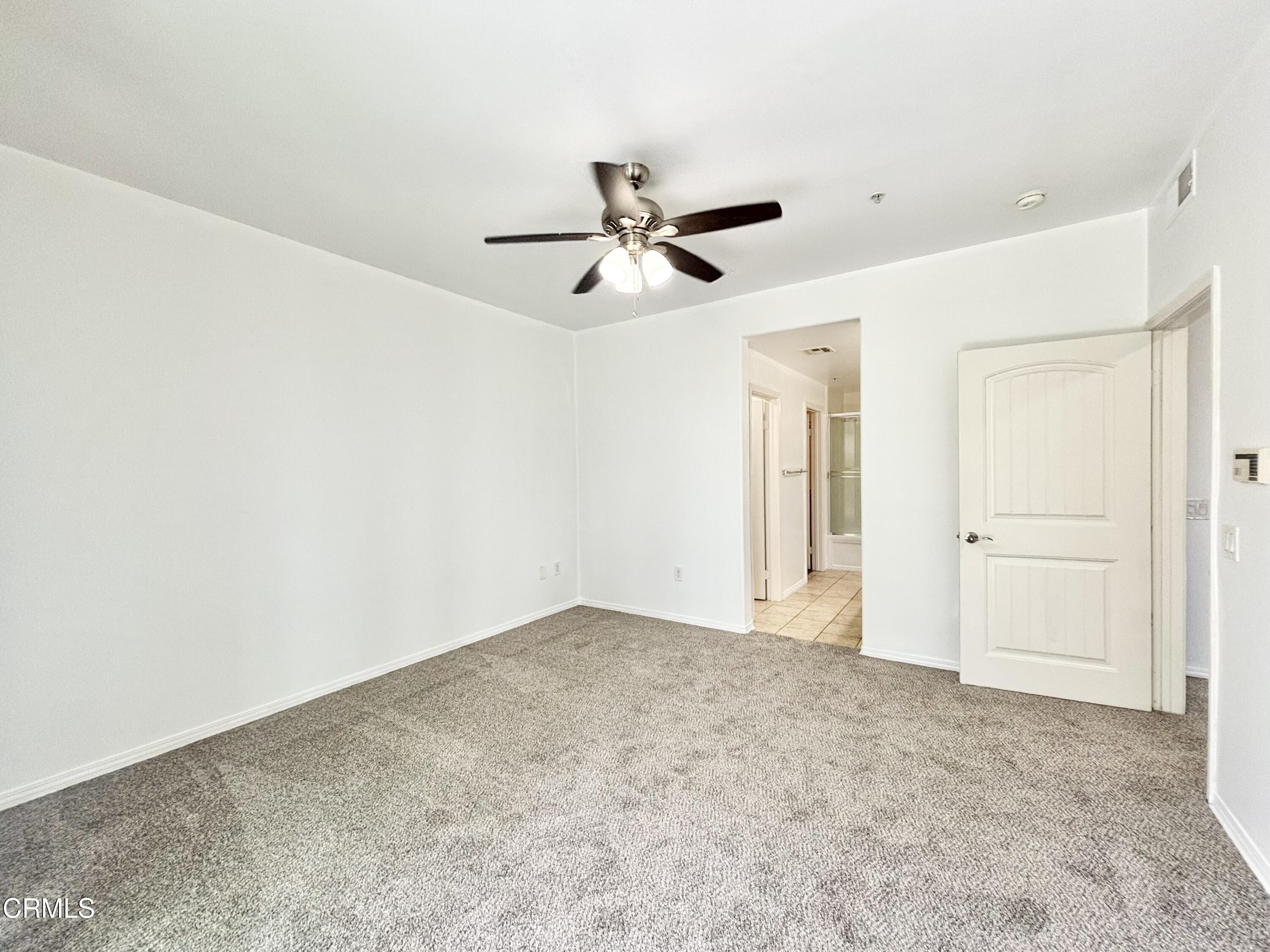 1544 Windshore Way Oxnard, CA 93035 - Photo 13 of 27 an empty room with closet and a ceiling fan