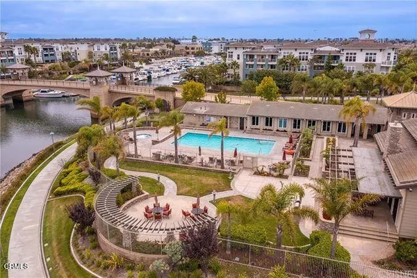 an aerial view of a house with swimming pool and lake view