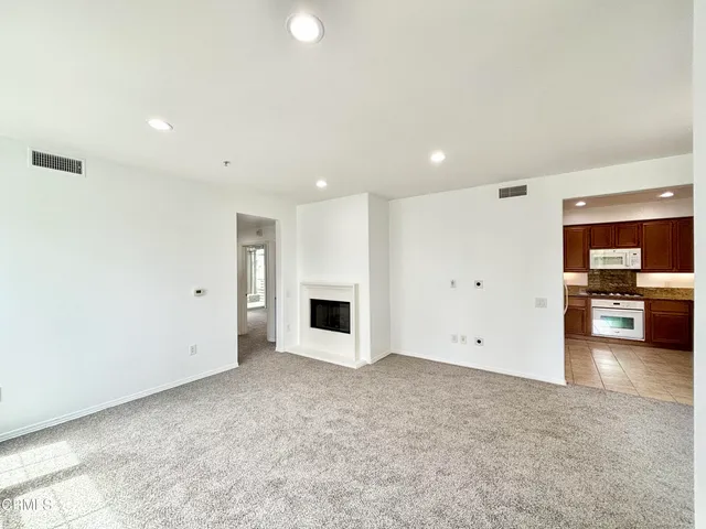 a view of a kitchen with a sink and a refrigerator