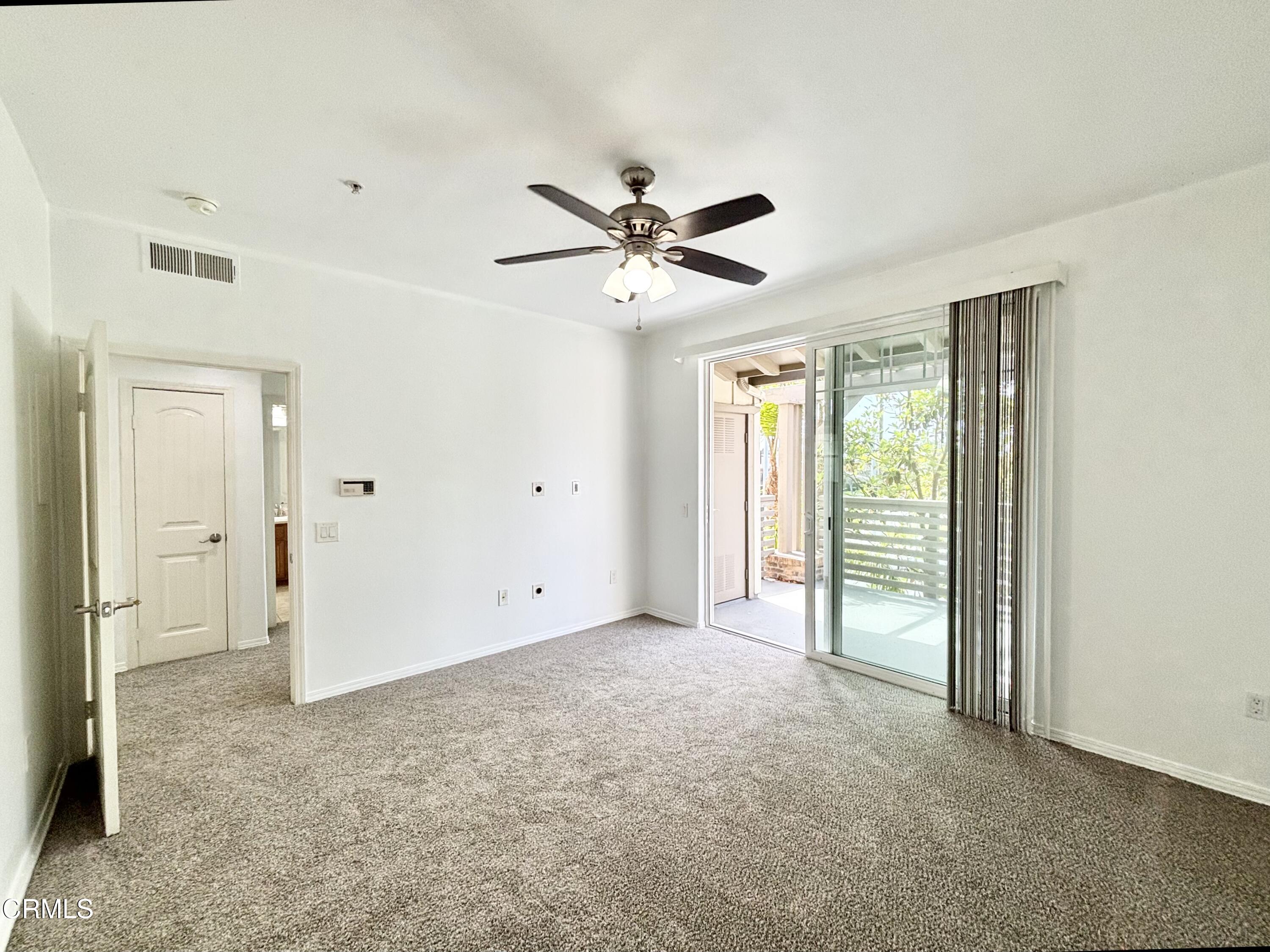 1544 Windshore Way Oxnard, CA 93035 - Photo 10 of 27 a view of a livingroom with a ceiling fan and window