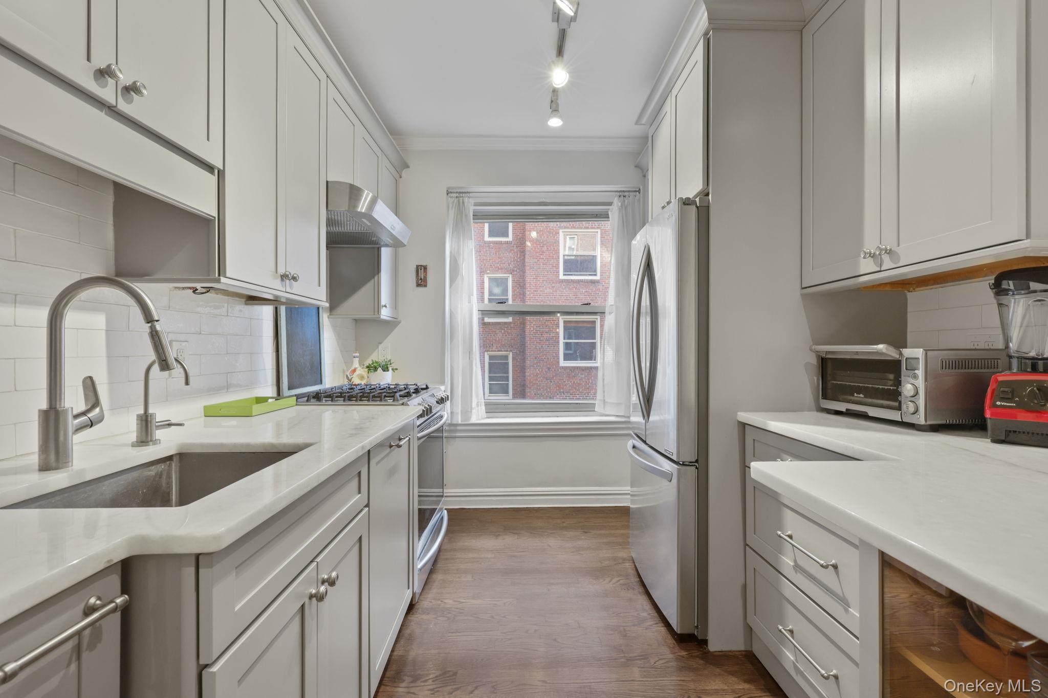 250 Bronxville Road, Unit 2G Bronxville, NY 10708 - Photo 8 of 14 a kitchen with a sink and a refrigerator