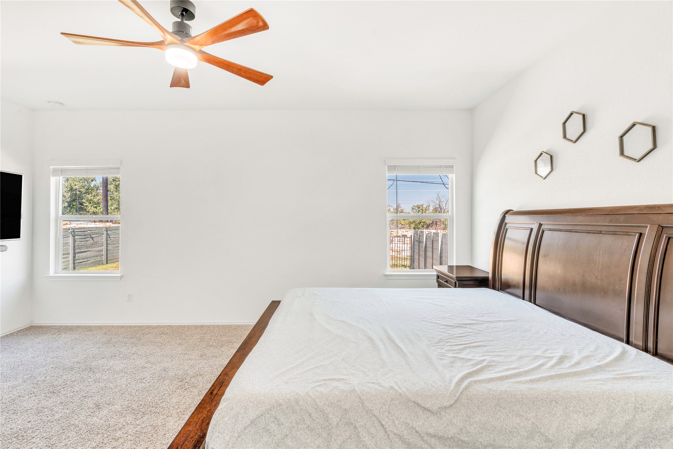 212 Saddle Mountain Road Georgetown, TX 78628 - Photo 12 of 38 a bedroom with a large bed and a chandelier