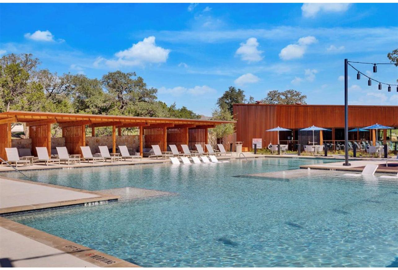 212 Saddle Mountain Road Georgetown, TX 78628 - Photo 33 of 38 a view of a swimming pool with a table and chairs