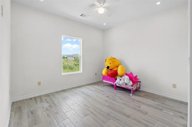 a view of a room with wooden floor and a window
