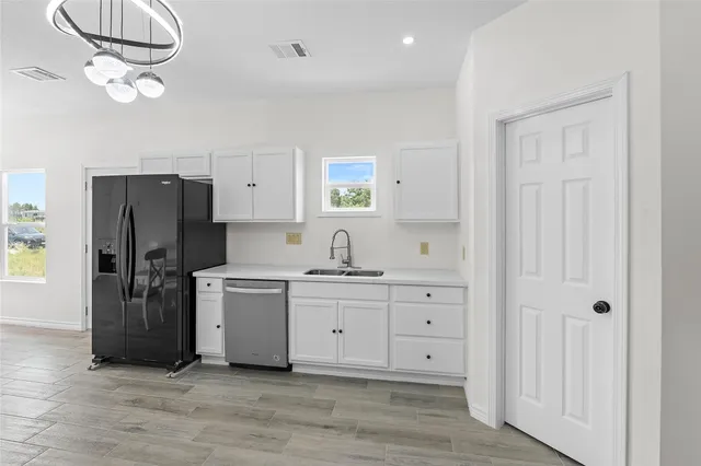 a kitchen with cabinets and stainless steel appliances