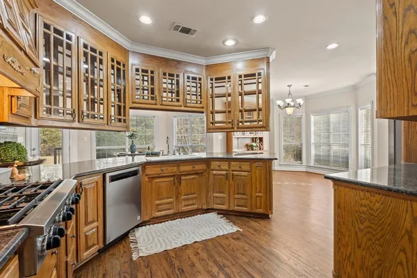 a bed room with a bed a television and a large window