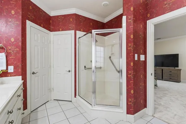 a view of staircase with white walls and white door