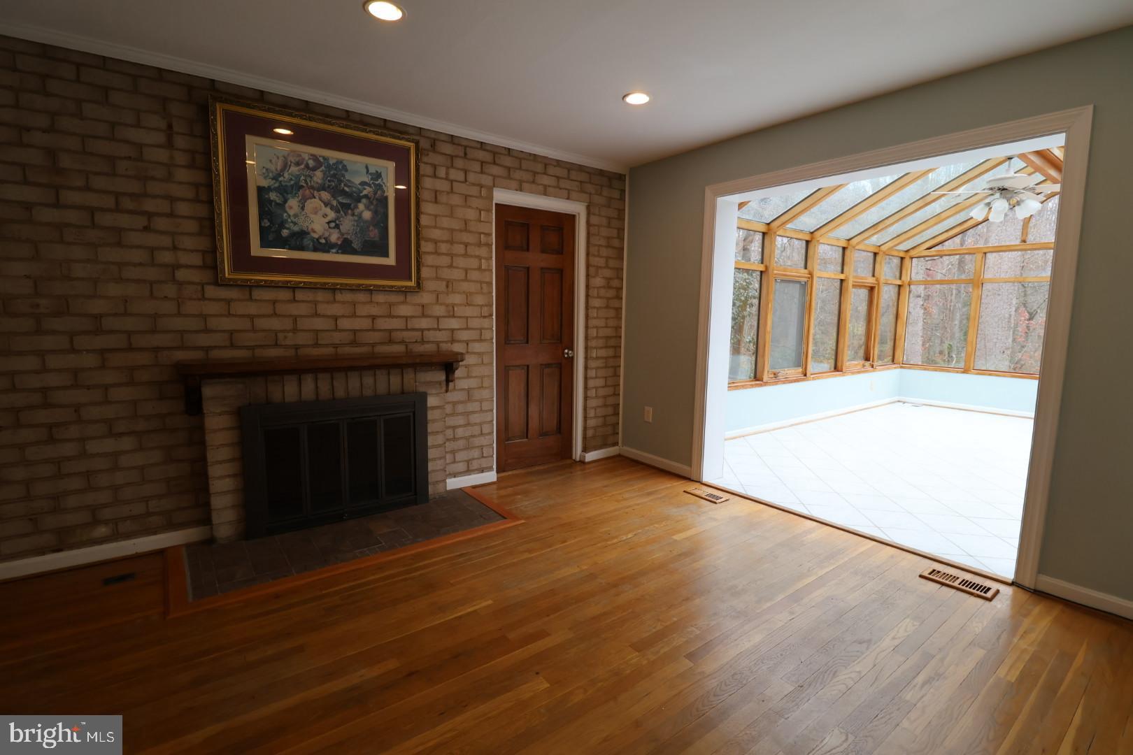 11312 Myrtle Lane Reston, VA 20191 - Photo 11 of 24 a view of an empty room with wooden floor and a window
