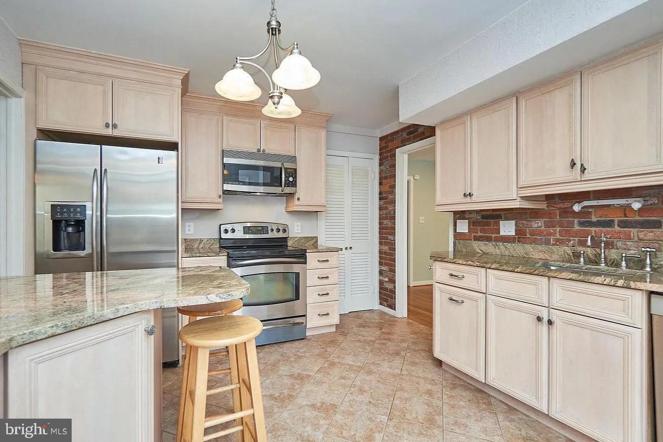 11312 Myrtle Lane Reston, VA 20191 - Photo 14 of 24 a kitchen with granite countertop a refrigerator stove top oven and sink