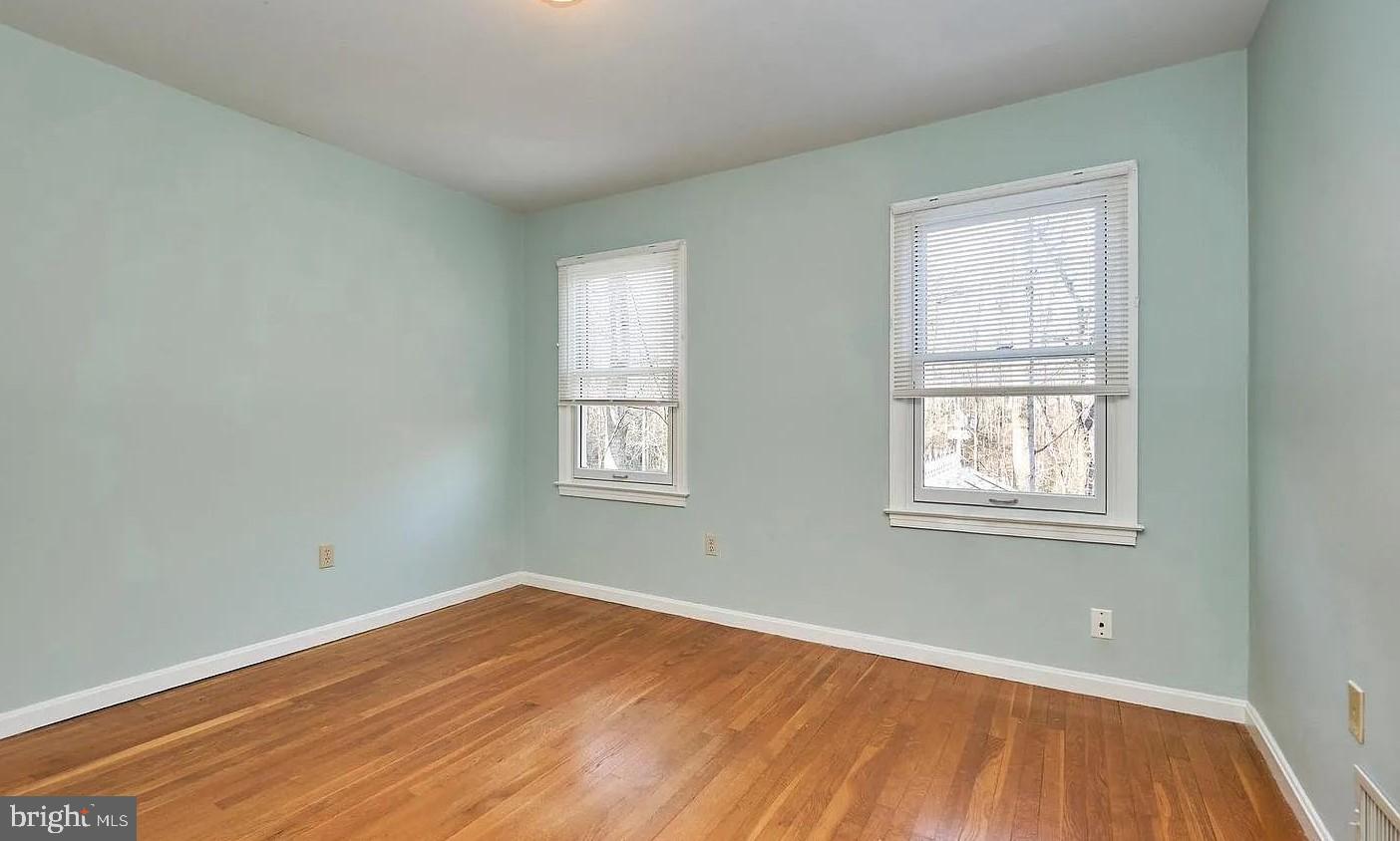 11312 Myrtle Lane Reston, VA 20191 - Photo 20 of 24 an empty room with wooden floor and windows