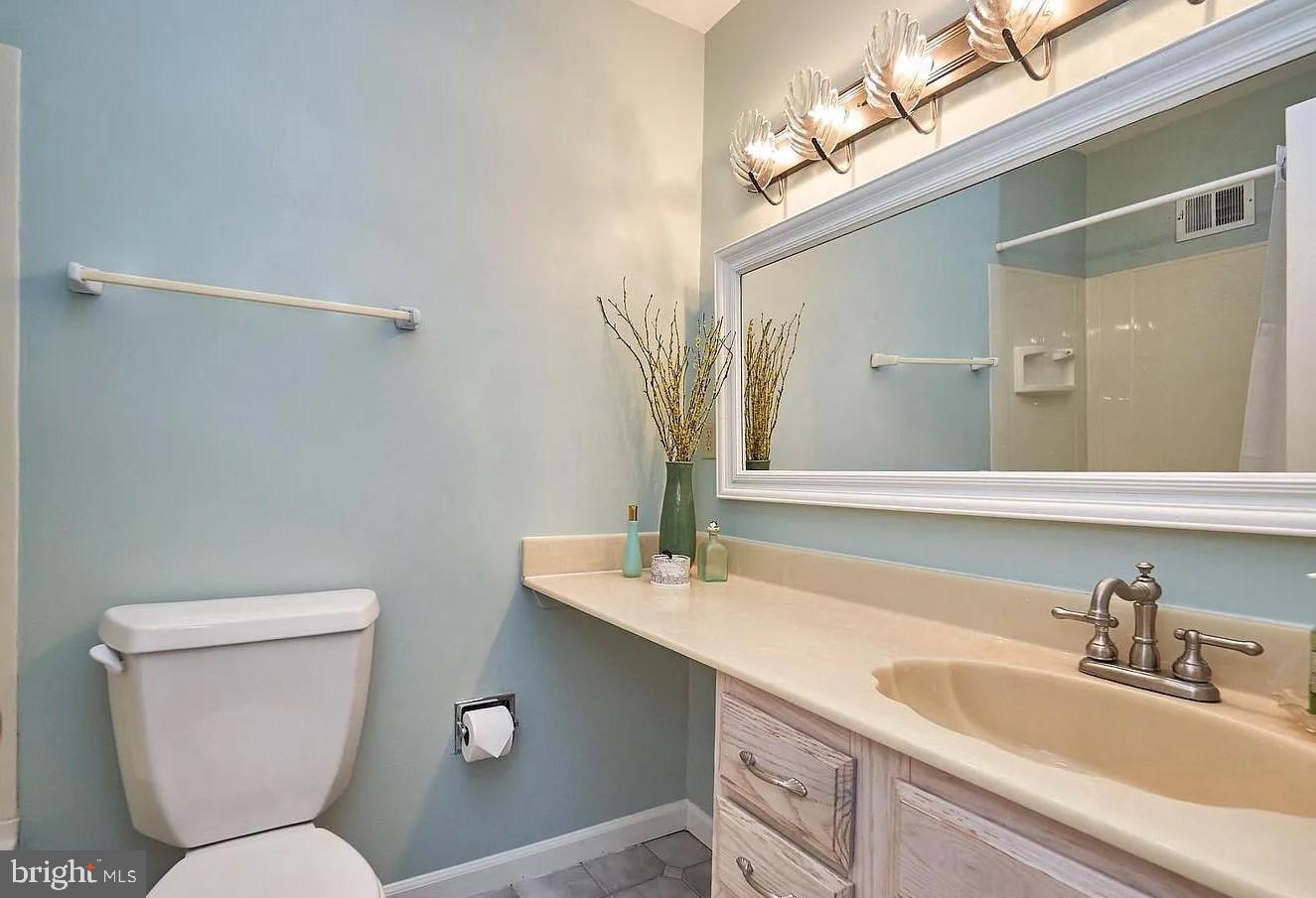 11312 Myrtle Lane Reston, VA 20191 - Photo 21 of 24 a bathroom with a toilet sink and mirror