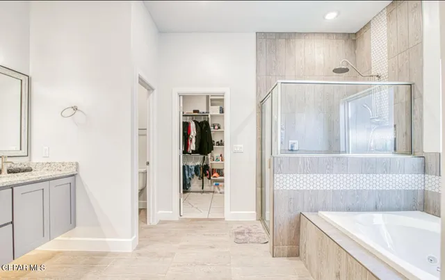 a bathroom with a tub sink and mirror