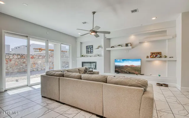 a living room with furniture a fireplace and a chandelier