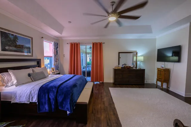 a bedroom with a bed and a flat screen tv