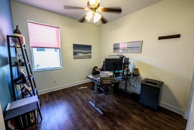 a view of a workspace with furniture and a window