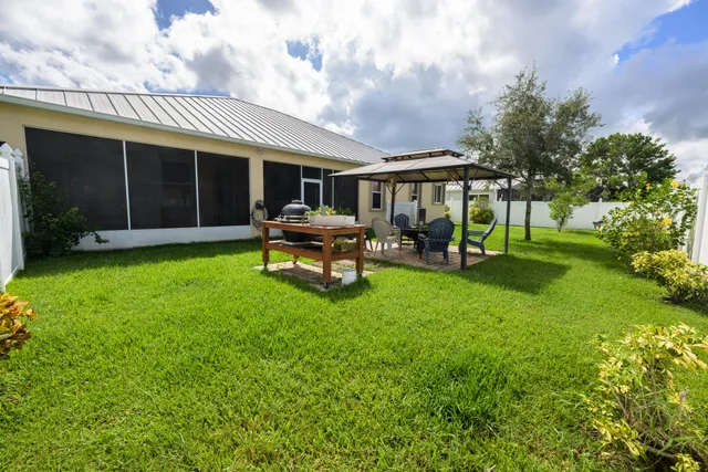 a view of a house with backyard porch and sitting area