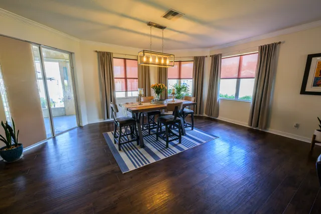 a view of a dining room with furniture window and wooden floor