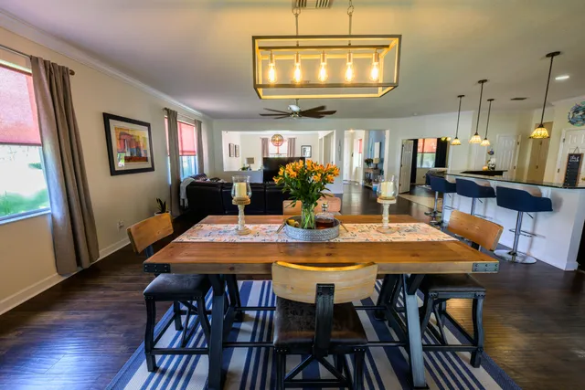 a view of a dining room with furniture and wooden floor