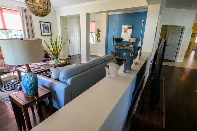 a living room with furniture and a wooden floor