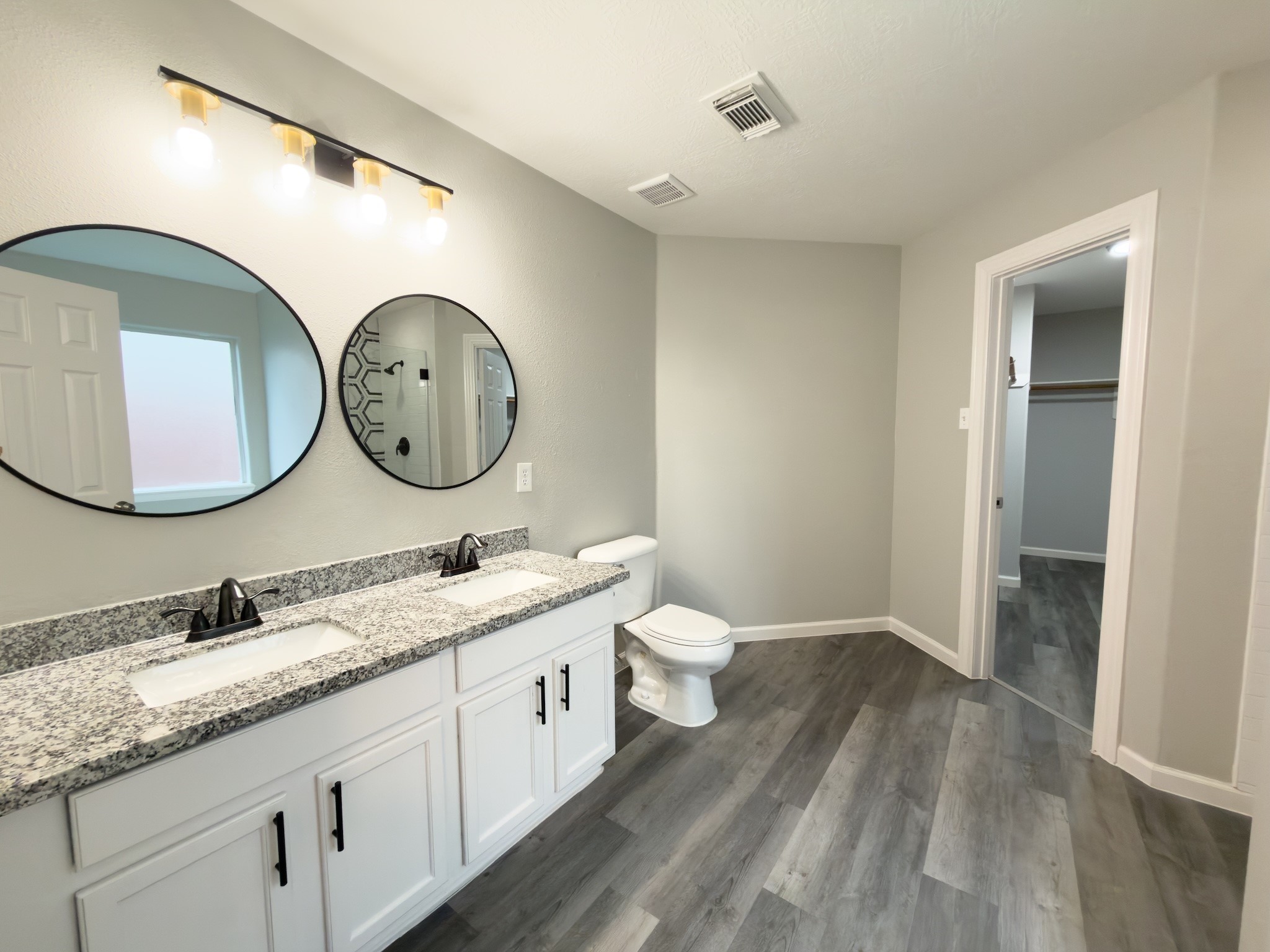 6626 Springfield Garden Lane Spring, TX 77379 - Photo 14 of 23 a bathroom with a double vanity sink and a mirror